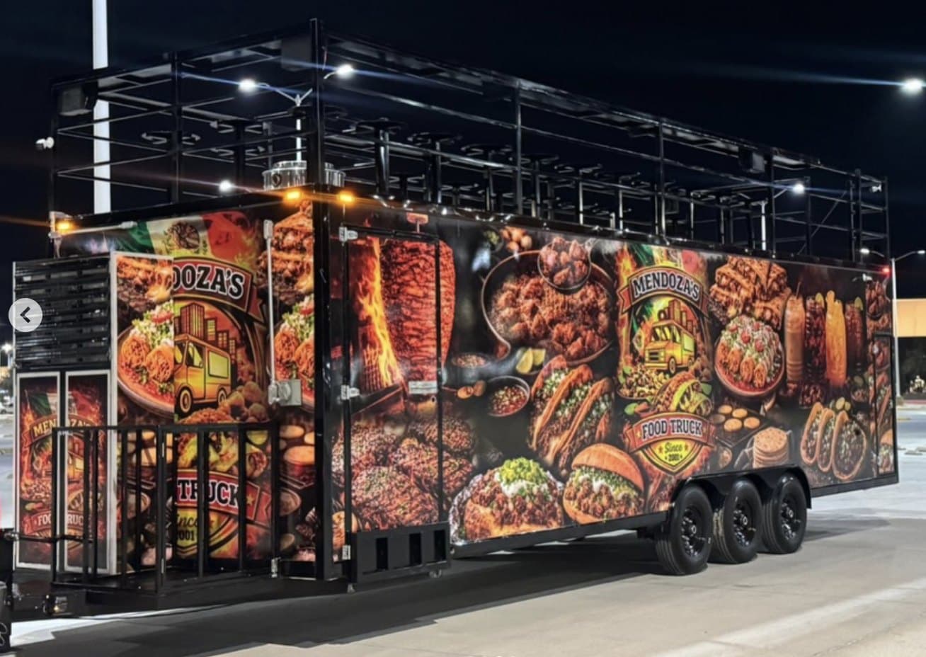 Mendoza's triple-axle double-deck food trailer at night